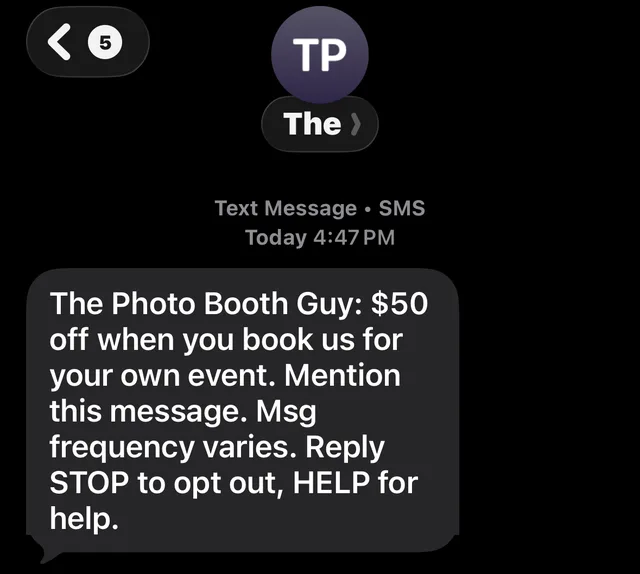 A text from The Photo Booth Guy offering $50 off when the guest books their own event, with message frequency and STOP and HELP instructions